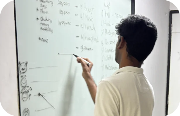Student sketching a user flow on a whiteboard at Aspira, Chennai